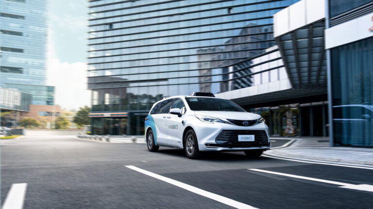 A Pony.ai vehicle drives down an empty urban road
