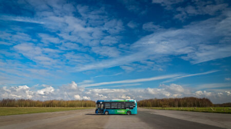 Fusion Processing advances NUIC technology for Level 4 autonomous operations An autonomous vehicle stands parked across a test track under blue skies with grass on either side and a tree line in the distance