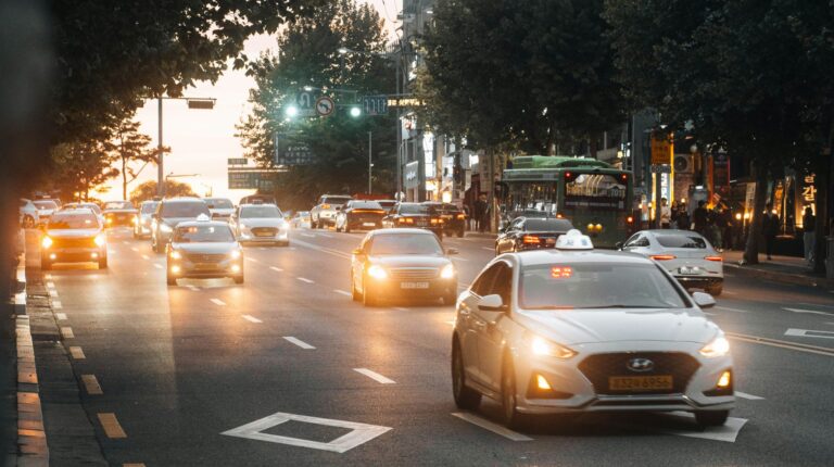 CAN in Automation launches special interest group for 48V transceiver testing Cars on an urban street with their headlights on in a low-light environment.